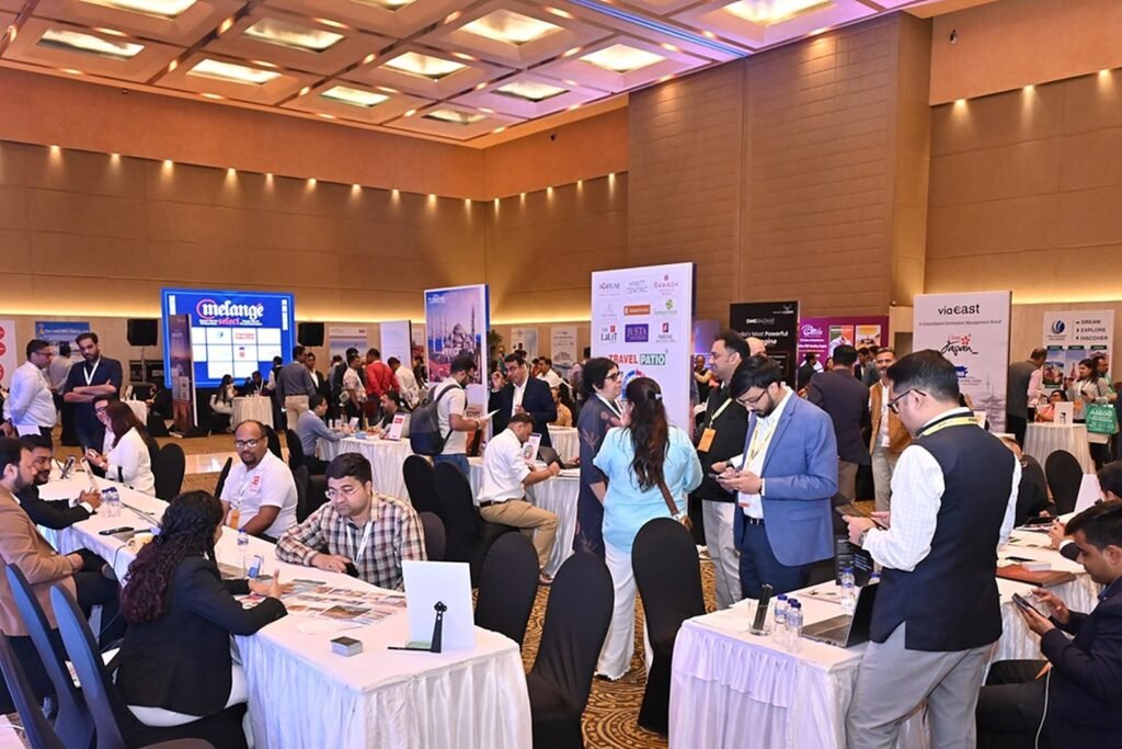 Mélange Select event floor with exhibitor booths and branded backdrop